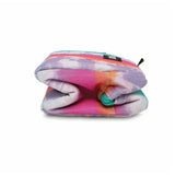 A folded fabric pouch or small bag with a pastel tie-dye pattern in pink, purple, orange, and teal, shown on a plain white background.
