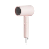 Pink hair dryer on a white background