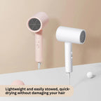 Two hair dryers, one pink and one white, on a light surface with a beige background.