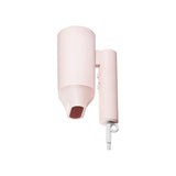 Pink lip gloss applicator with a small amount of red lipstick on a white background