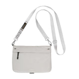 A light gray crossbody bag with a matching adjustable shoulder strap, featuring a zippered front pocket and a small black and yellow brand tag.